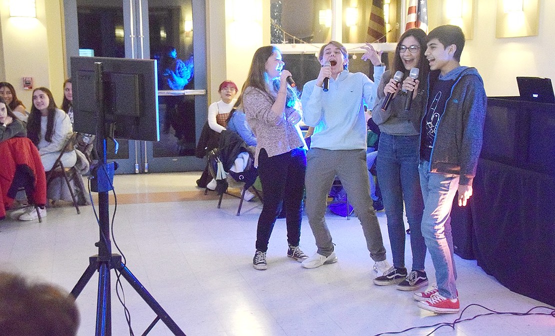 Keeping with the Disney theme, Port Chester High School sophomores Angelia Fallanca (left), Harrison Callaway, Riley Heffernan and Ivan Lopez animatedly sing “Let It Go” from Frozen.