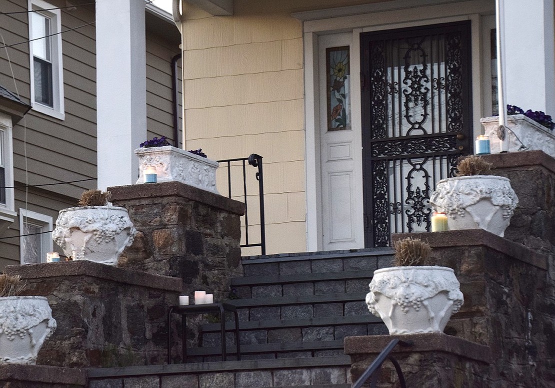 Candles line the stairs of 481 Westchester Ave.