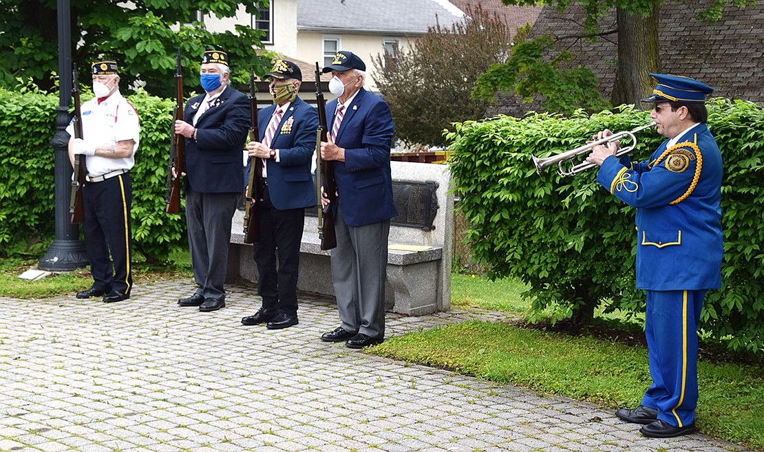 Port Chester American Legion Firing Squad members Kenny Neilson, Bill Chiappetta, Tommy Giorgi and Vinny Lyons stands at attention while bugler Anthony Bubbico Jr. plays Taps.