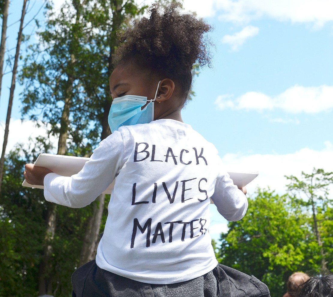 Three-year-old Rectory Street resident Janiah Foust sits on her father’s shoulders during a Black Lives Matter peaceful protest in Columbus Park.