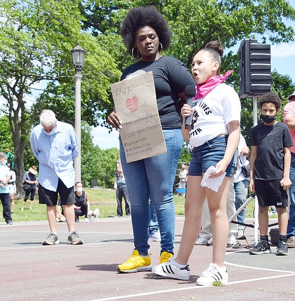 Quoting the last words George Floyd spoke, White Plains 16-year-old Zaida Polanco raises a sign reading “I can’t breathe” above all heads at Columbus Park.