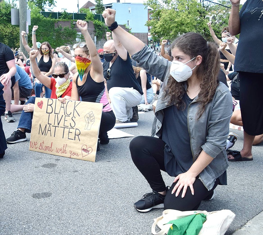 King Street resident Jennifer Gomes, 28, feels the discomfort alongside the 2,000 other protesters kneeling simultaneously for over 8 minutes to recognize George Floyd’s death.