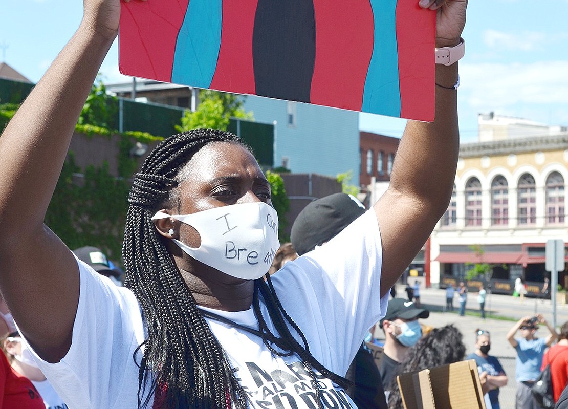 “I can’t breathe” is written across Grace Church Street resident Felicia Avila’s mask as she peacefully protests on New Broad Street. 