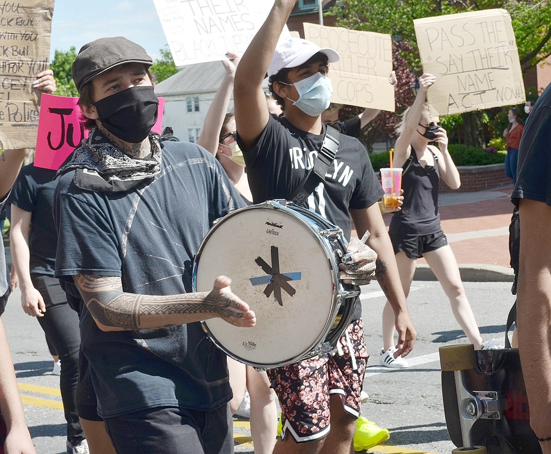 Marchers walk to the beat of Fairfield, Conn. resident Dylan Graham’s drum.