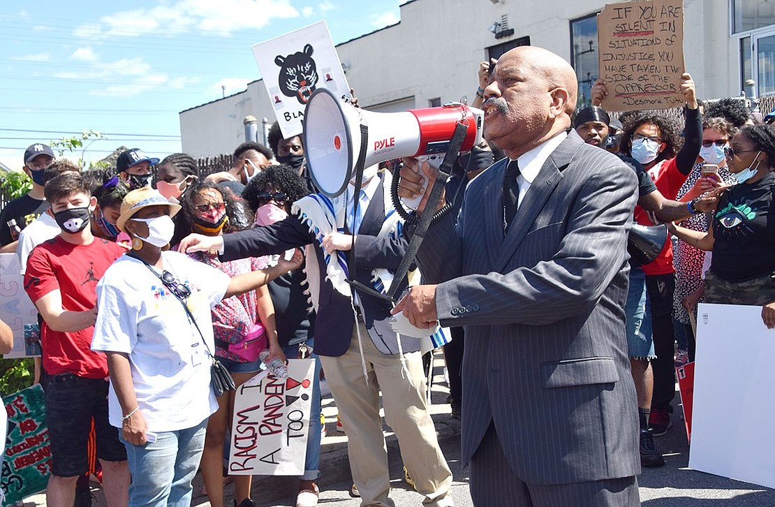 With thousands of protesters outside his church, Girtman Memorial Church of the Living God pastor Bishop Robert Girtman riles up the crowd with chants about equality.