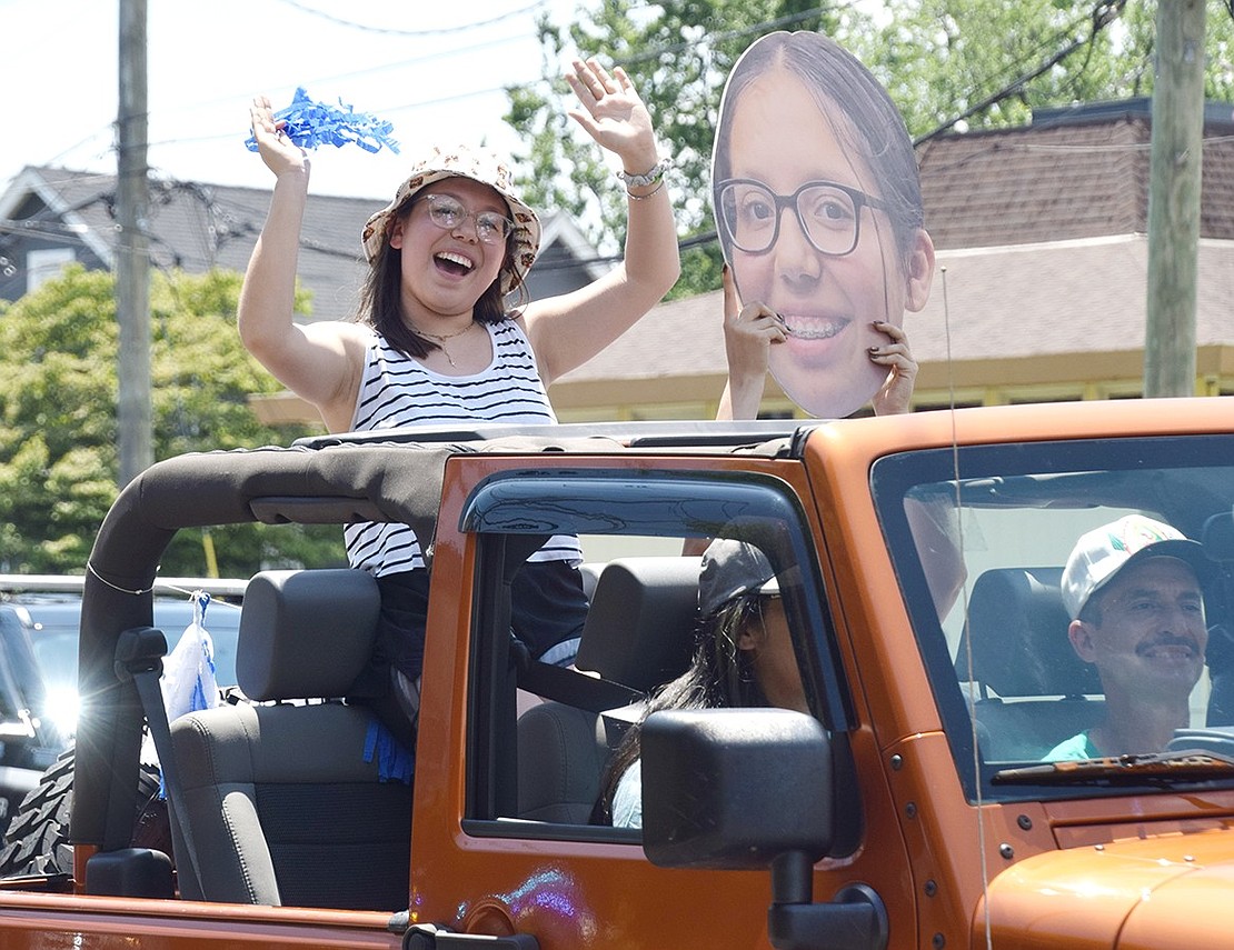 Showing the world on North Regent Street a personal blast from the past, Port Chester High School senior Matilde Garcia dances out of an open Jeep with a giant cutout of her face as a younger student. She was one of hundreds of seniors celebrating their pre-graduation pride during a car parade on Sunday, June 21.