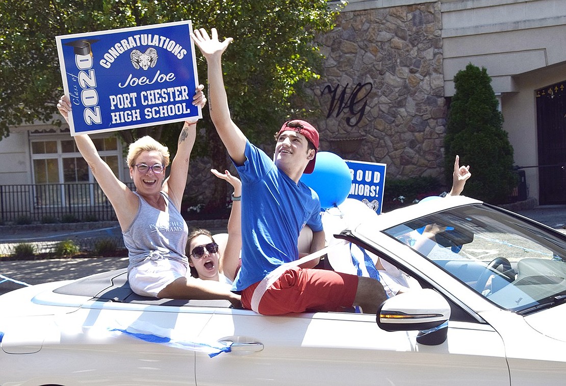 Riding in a convertible with his fervently excited family, senior Joseph “Joe Joe” Pastore waves up at Westchester Avenue apartment dwellers cheering down.