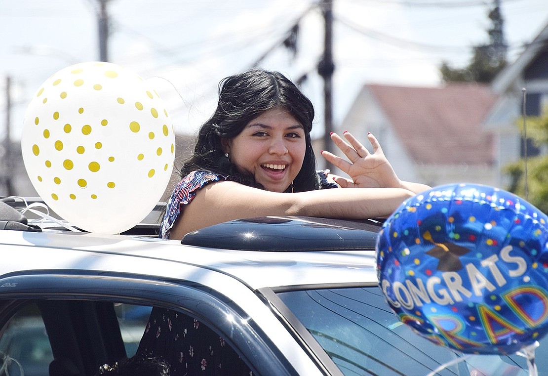 With a coy smile, senior Victoria Sosa waves to Class of 2020 fans on North Regent Street.