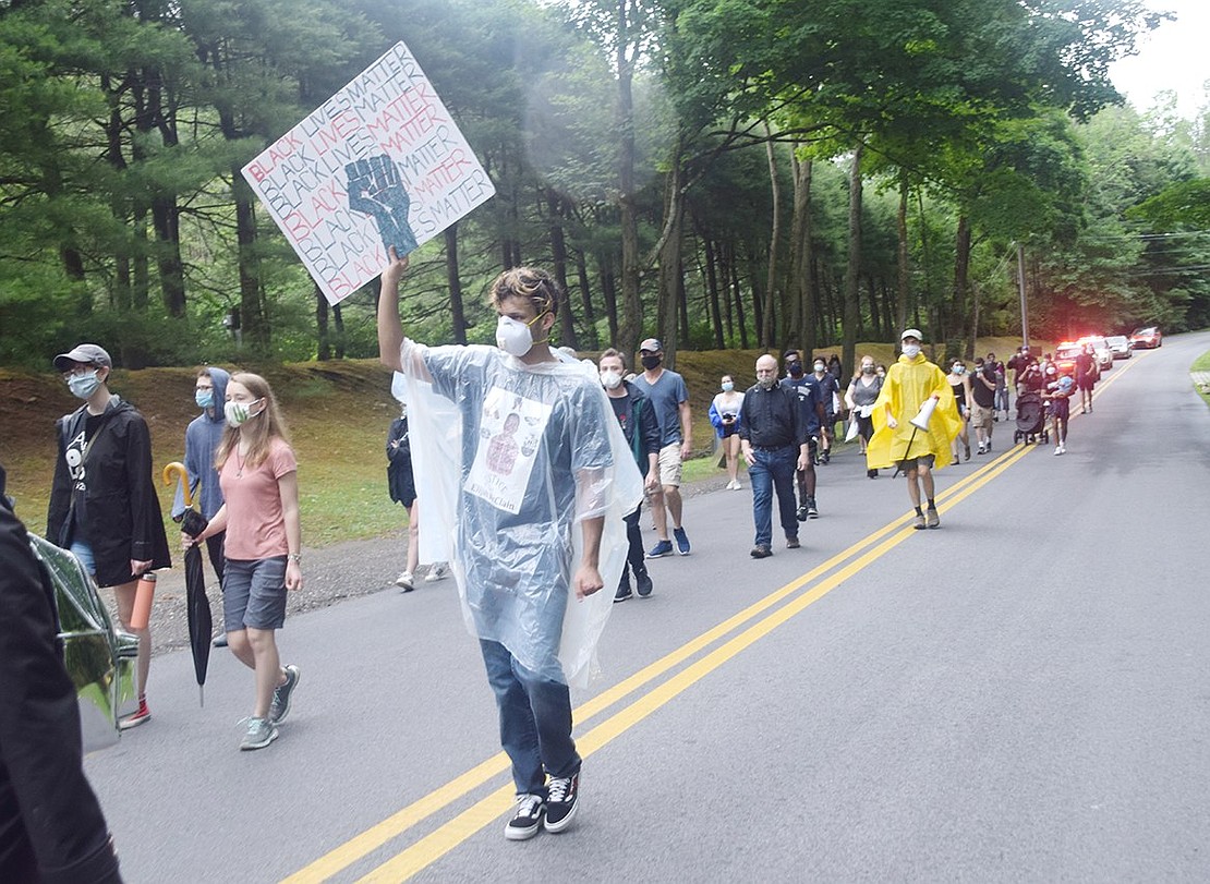 A group of about 50 people walk along Lincoln Avenue and call for an end to police brutality nationwide.