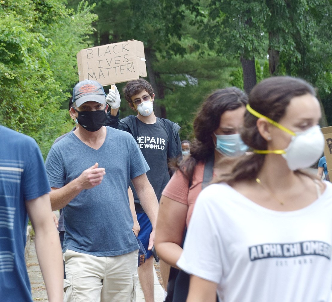 Soon-to-be Class of 2020 graduate Abe Baker-Butler holds up a sign that reads Black Lives Matter! 