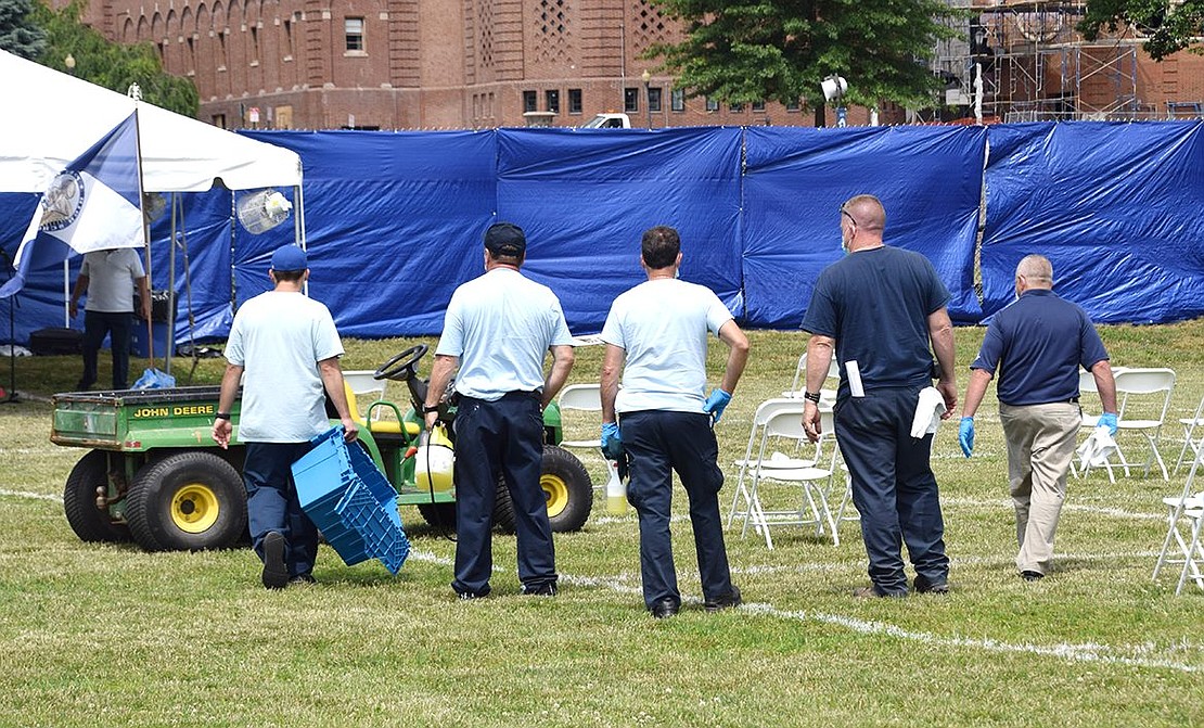 Between each of the nine ceremonies, a crew scatters across the field to sanitize every space before the next group of graduates arrive.