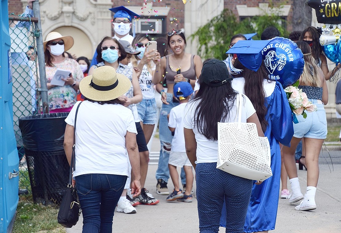 Confetti flies at the Park Avenue exit as Nina Reyes, clutching her Rams balloon, leaves as an official graduate with her mother Blanca Montano (right) and grandmother Maria Zurita.