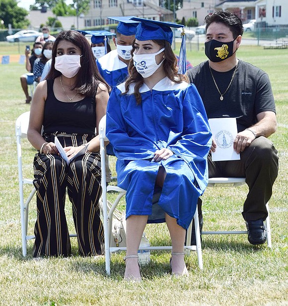 Trailing the end of her row of classmates about to officially graduate, Jasmine Torres’ hair blows in the wind as she patiently waits for her name to be called.