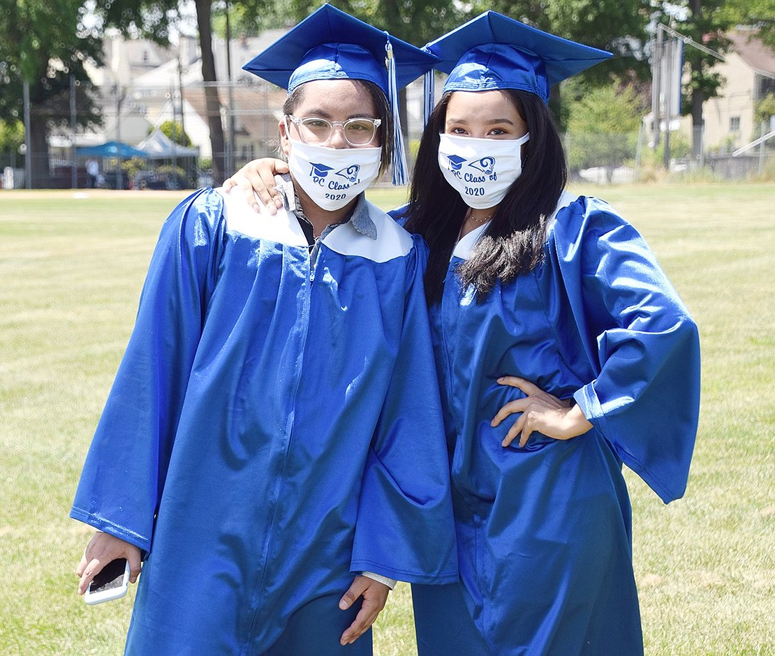 Officially graduated, Juan Mori (left) and Angelie Aucay pose for one more photo before walking off the Port Chester High School property as alumni.