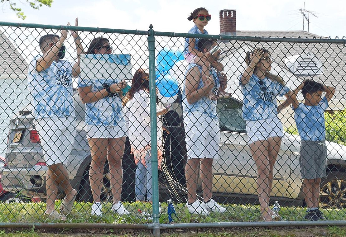 Though they couldn’t be on the baseball field due to COVID-19 mandates, the Del Cid family watches in matching shirts behind the fence on Neuton Avenue to cheer for Matthew Del Cid when his name is called.