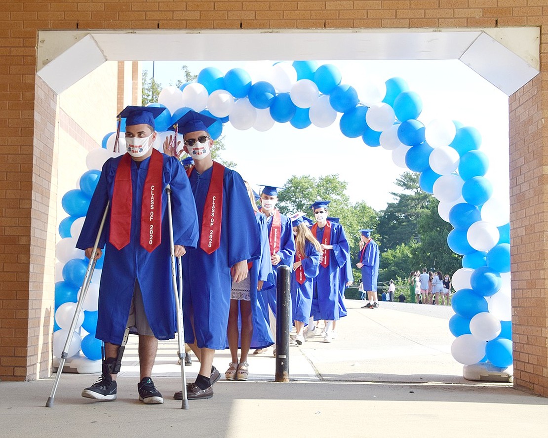 As “Pomp and Circumstance” begins, Sage Asencio leads the Blind Brook High School Class of 2020 graduates through a blue and white balloon arch and onto the football field for graduation on Sunday, July 26.