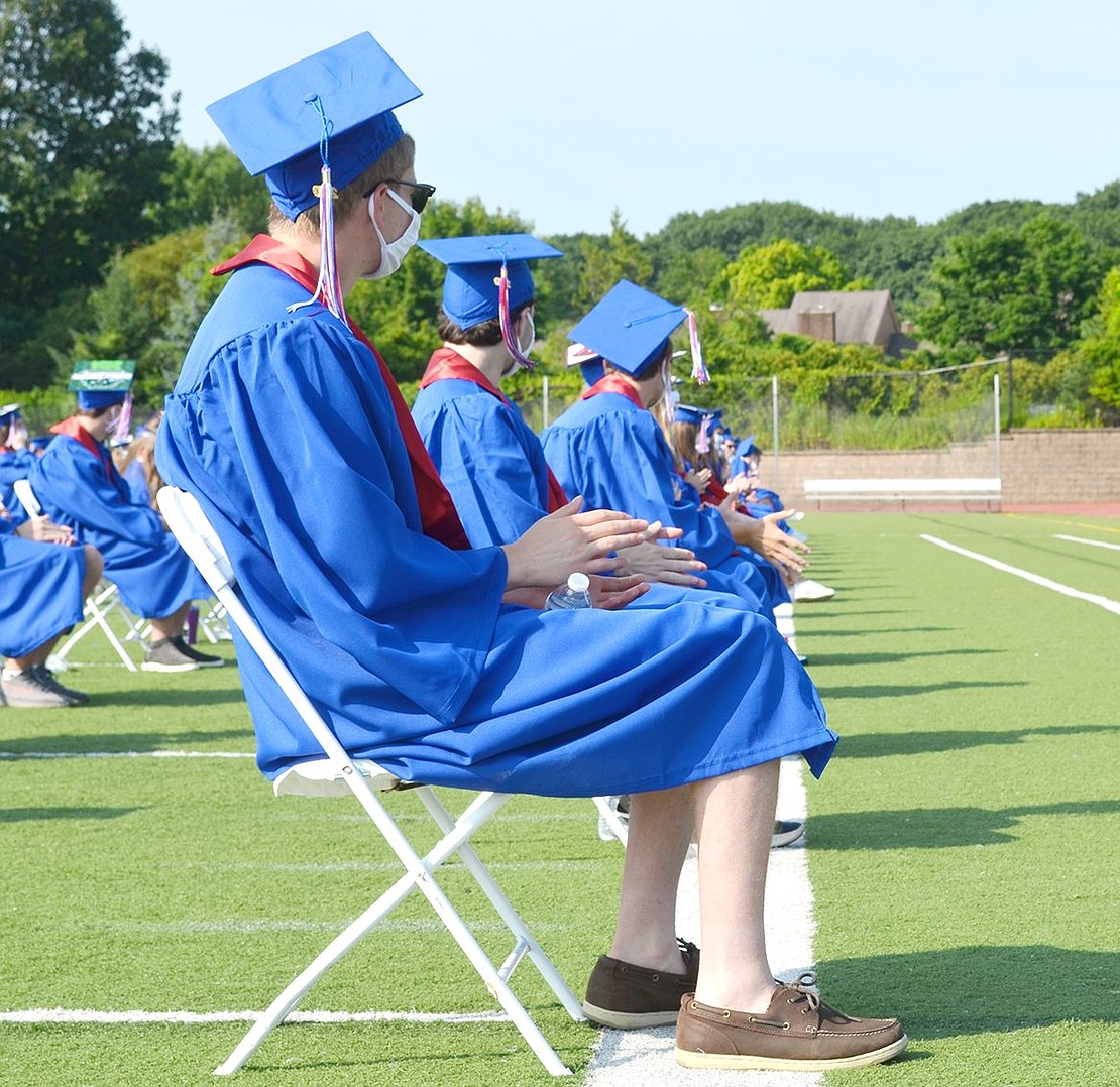 Patiently clapping for speakers, Albert Zottola has a long way to go before receiving his diploma as the last name to be called during the ceremony.