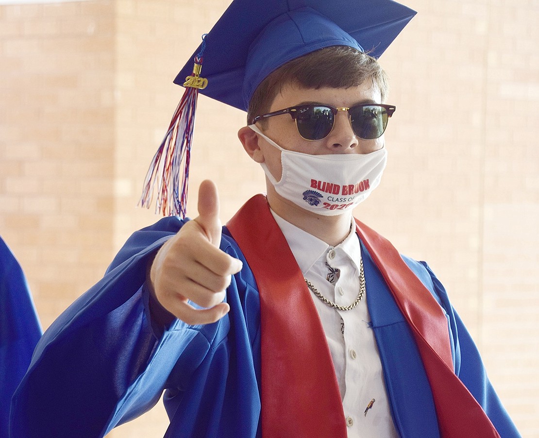 Cole Finocchio gives a thumbs up for graduation!