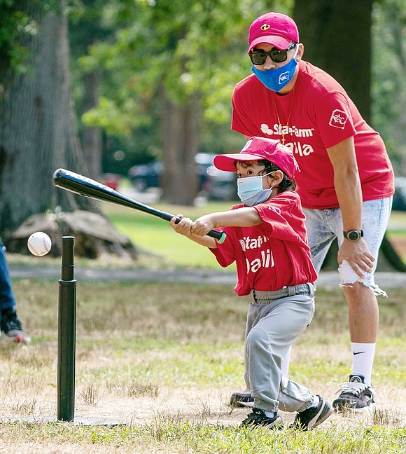 Taking the game of baseball seriously, Oliver Barrenechea slugs the ball off the T during play by kids 5 and under in the Port Chester Youth Baseball League’s summer T-ball program last month at Lyon Park.