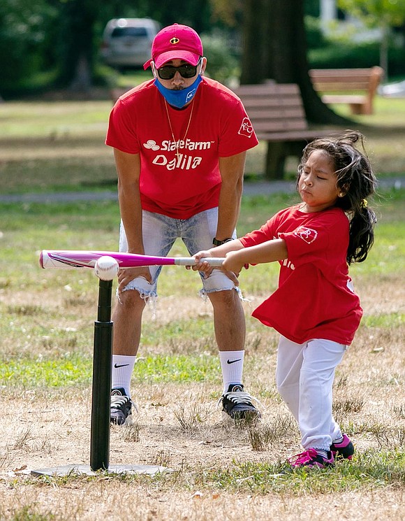 Mia Carranza gives it her best shot to whack the ball off the T.