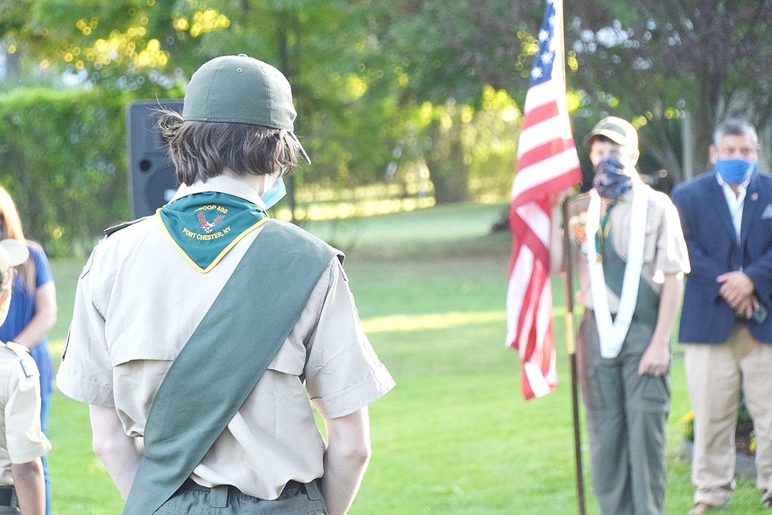 On the 19th anniversary of the Sept. 11 terrorist attacks, Boy Scout Troop 400 member Matthew Shearer, 15, bows his head during a moment of reflection at the annual Remembrance Ceremony in Lyon Park to honor the lives lost in the tragedy. Residents and local politicians maintained social distancing due to the ongoing COVID-19 pandemic as they gathered at the 9/11 memorial to honor the victims and first responders.