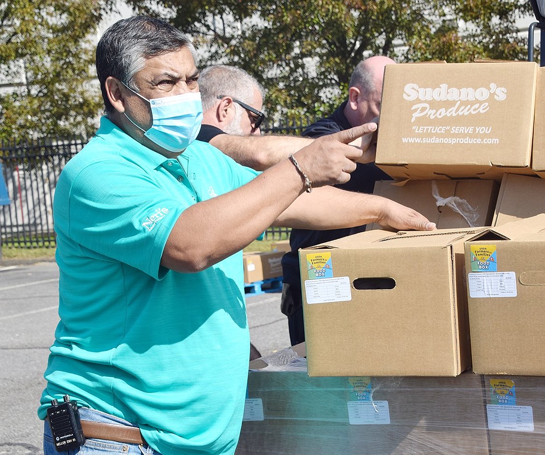 Port Chester Trustee Luis Marino provides a helping hand to volunteers and the Port Chester Police Department as they load individuals’ and organizations’ trucks with fresh produce.