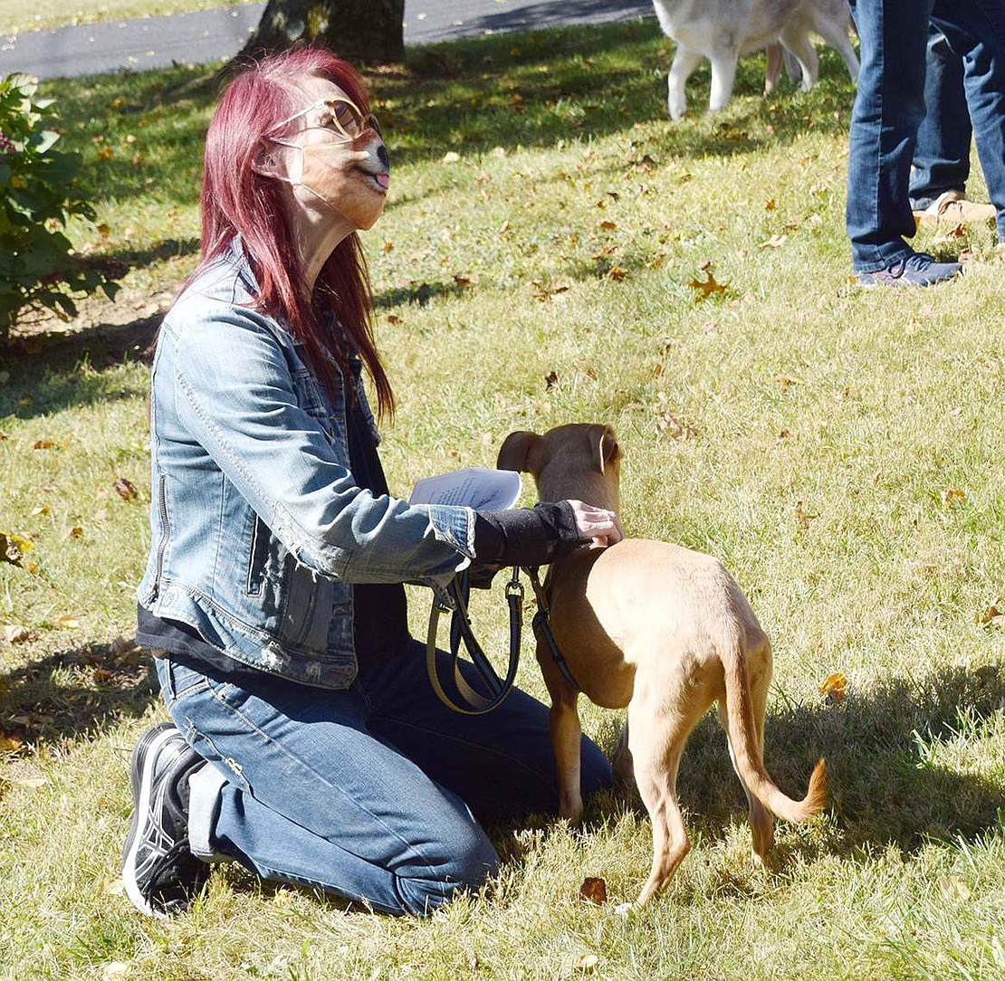 Greenwich, Conn. resident Jen Mason keeps her dog Betty calm as she eagerly looks around hoping to make some new friends.