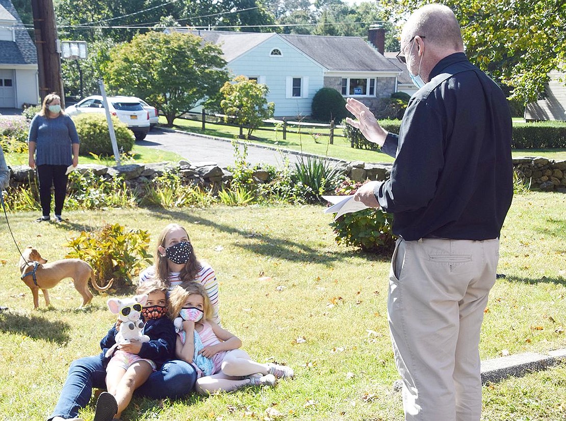 All kinds of animals received a blessing during the ceremony! Rye residents Ava and Audrey Gallego (right), along with their mother Katie, receive a benediction from St. Paul’s Pastor Jim O’Hanlon for their stuffed animals.