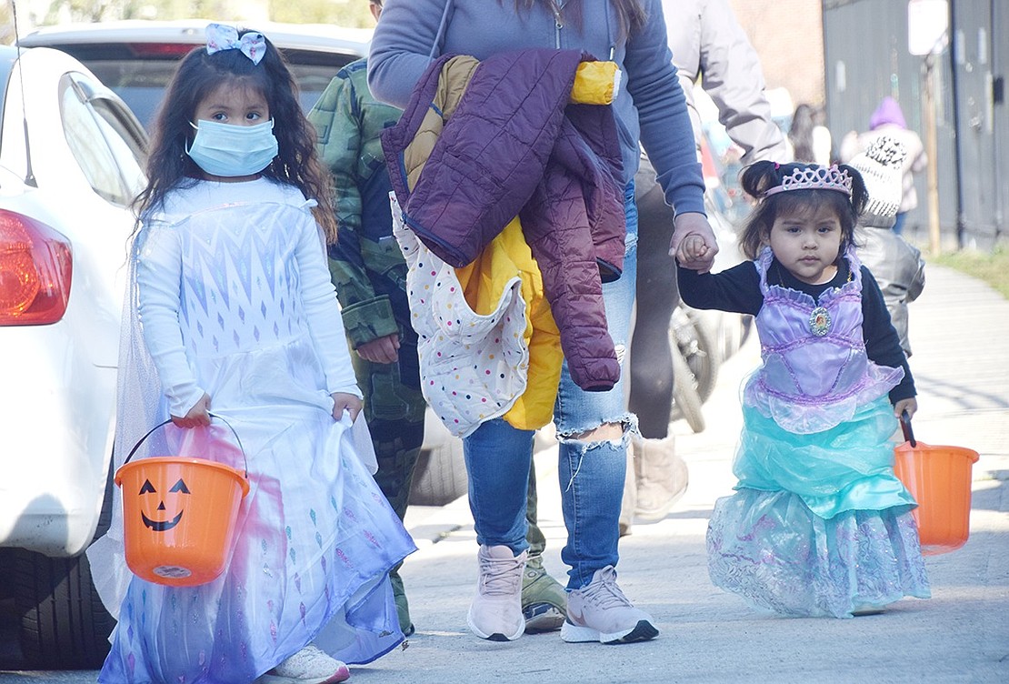 Royalty showed up to the Unity Day Halloween Candy Giveaway on Saturday, Oct. 31, as 18-month-old Rebecca Torres (right) and her sister April, 4, show up in style at Columbus Park. Since the annual Port Chester Housing Authority reunion and basketball tournament could not take place this year, the Unity Day Committee has been hosting small events aimed at aiding the Port Chester community.