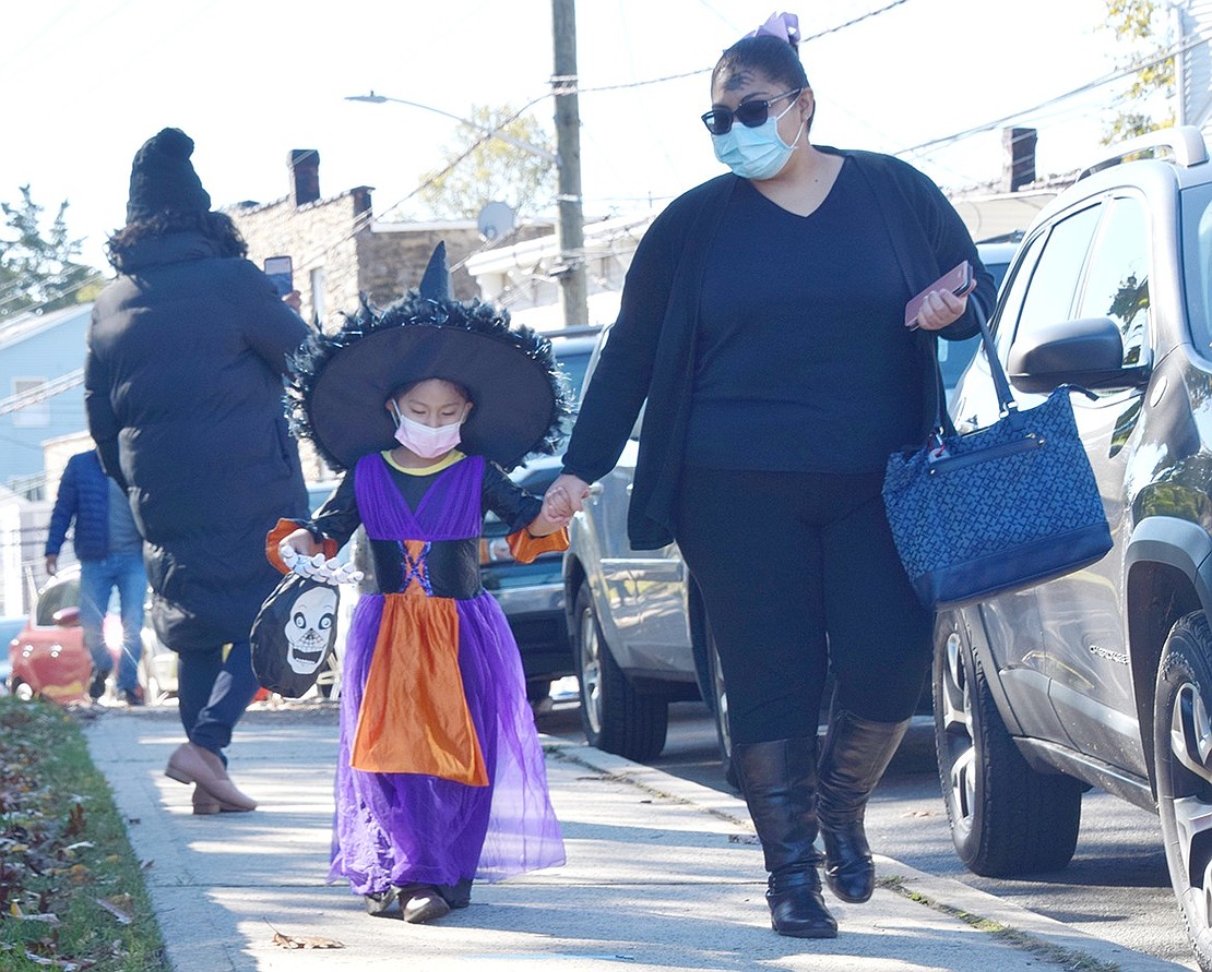 Willett Avenue resident Samantha Zhuin is ready to cast a spell on anyone who does not give her candy as she and her mother Jessica walk up to Columbus Park.