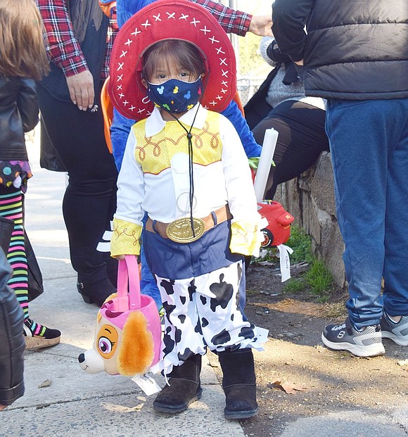 Locust Avenue resident Luna Paulino, 2, looks to wrangle up some candy while dressed up as Jessie from “Toy Story 2.”