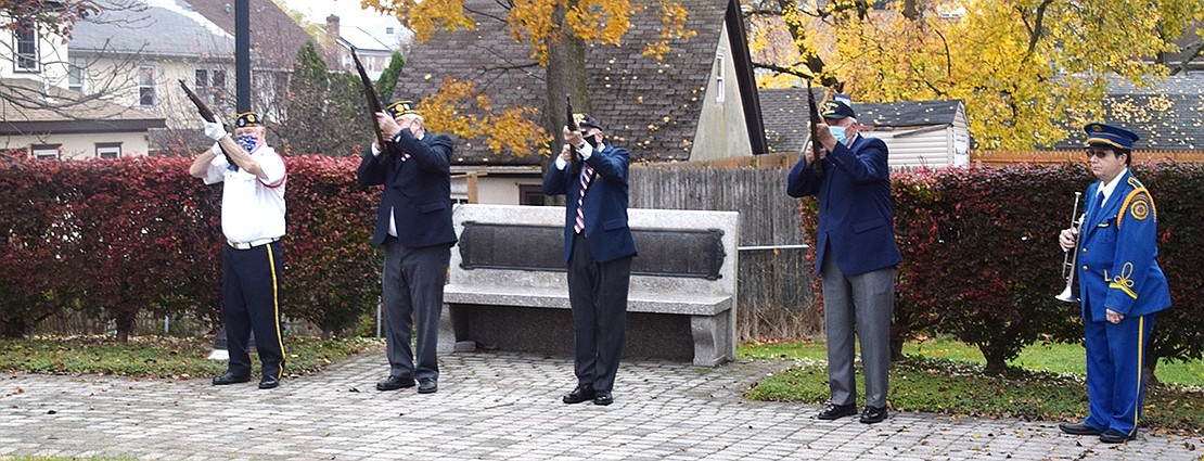 Port Chester American Legion Firing Squad members Kenny Neilson, Bill Chiappetta, Tommy Giorgi and Vinny Lyons fire shots to honor all veterans while bugler Anthony Bubbico Jr. stands ready to play Taps in memory of those who have died.