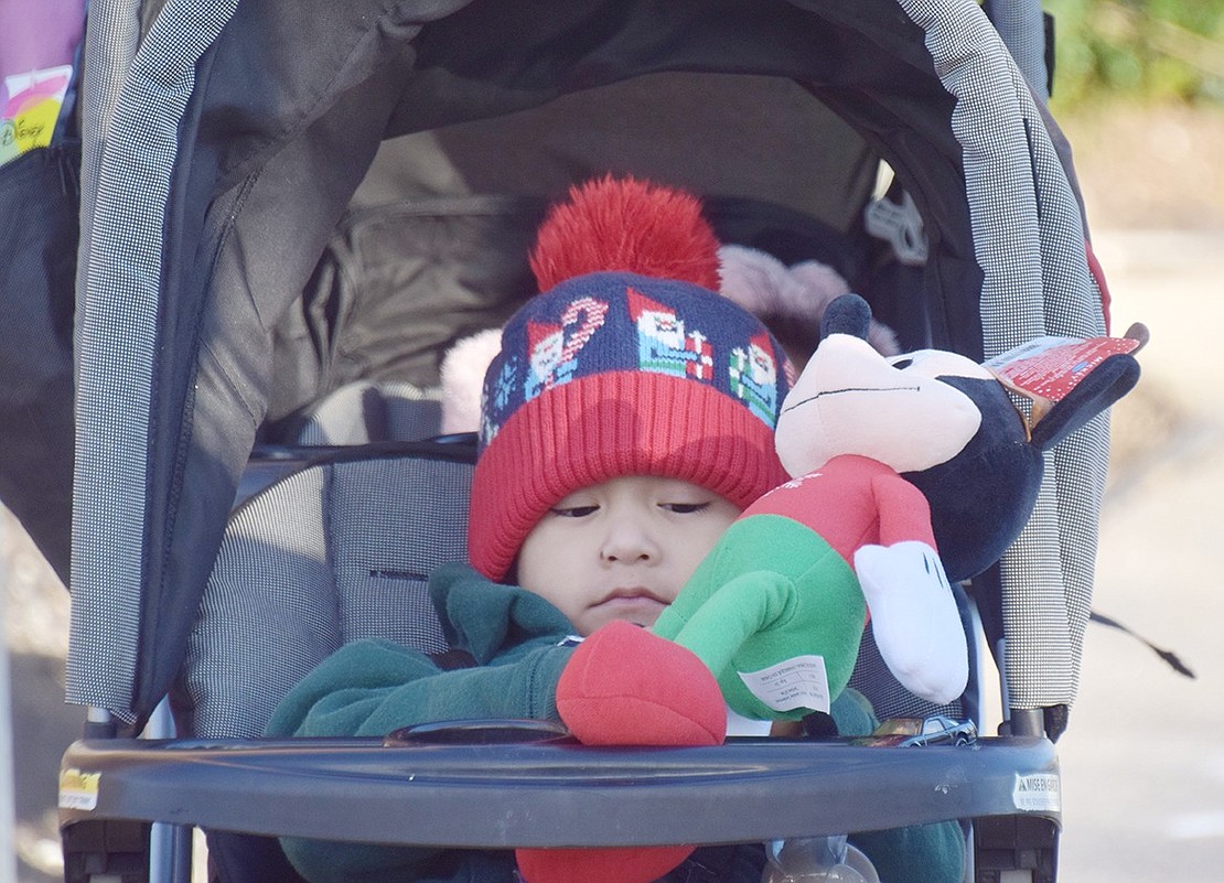 Christmas came early for Marco Antonio Flores, 2, who plays with his new Mickey Mouse toy.