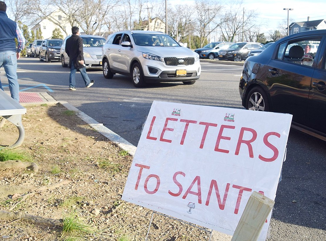 A line stretches from the Port Chester Senior Community Center to the bottom of Grace Church Street as over 750 families wait for their chance to greet Santa Claus.