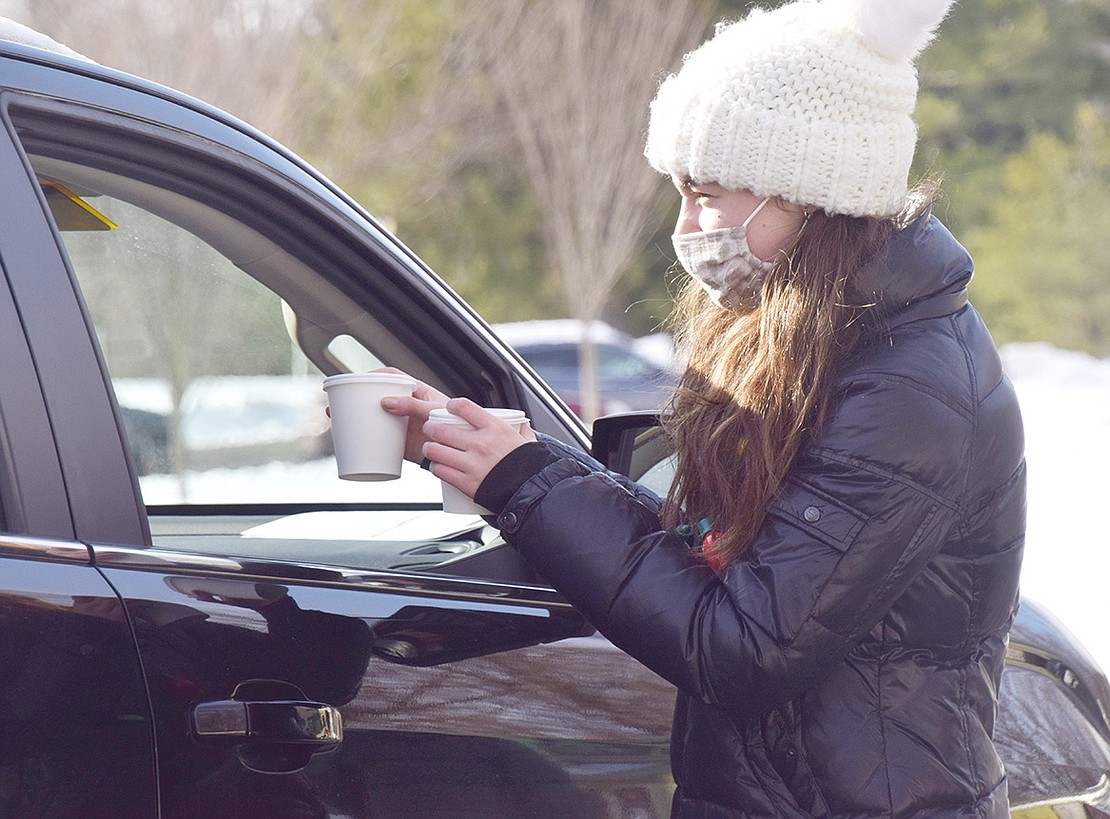 Rye resident Lauren Salomon, 16, hands out free cups of hot chocolate supplied by Caffe Bon, a mobile expresso bar.