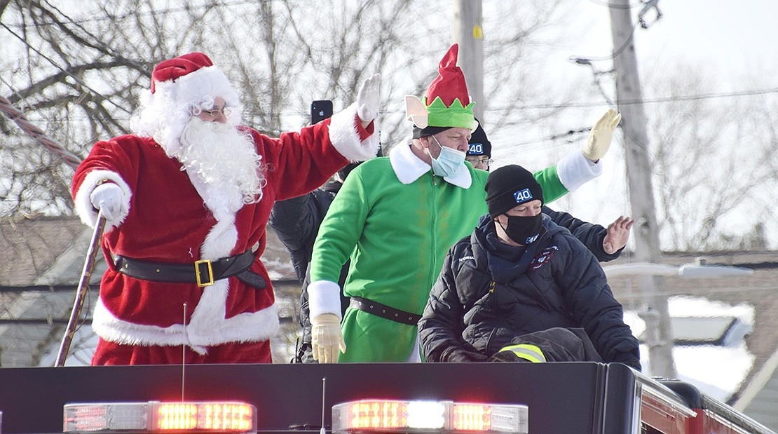 With the help of the Port Chester and Rye Brook fire departments, Santa Claus, who also goes by Richard Longo, and his elf friend Edward Garrity greet eager children on Parkway Drive. Mr. Claus visited numerous locations across the villages on Saturday, Dec. 19 to wish everyone a merry Christmas.