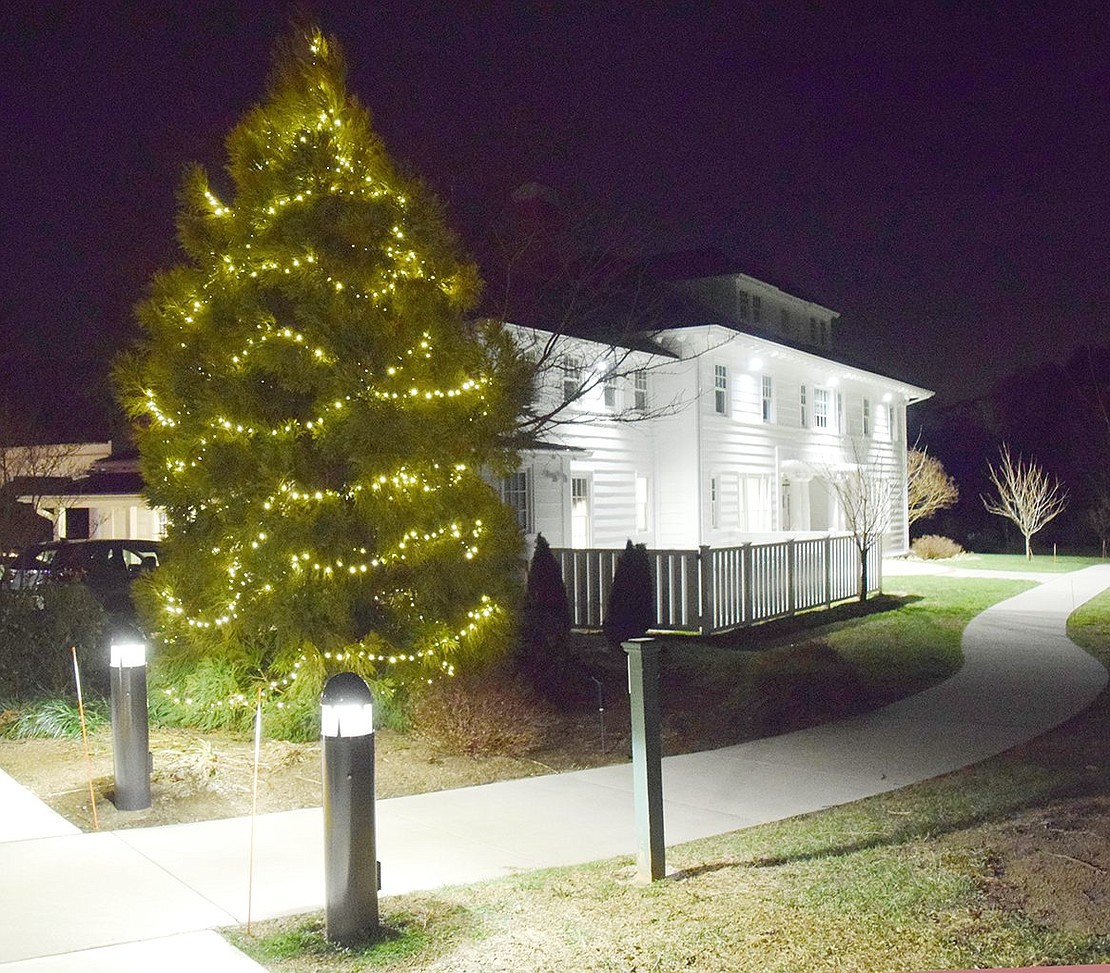 Elegantly lit trees surround the Crawford Mansion Community Center to create a warm, festive atmosphere for the holidays.