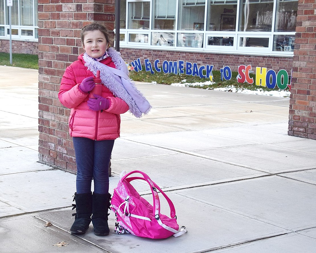 Second-grader Samantha Allen is the first in line waiting to go inside King Street Elementary School to partake in her second day of in-person classes on Wednesday, Jan. 20. Students across the Port Chester School District were welcomed back into the buildings for hybrid learning this week, seeing teachers face to face for the first time since November.