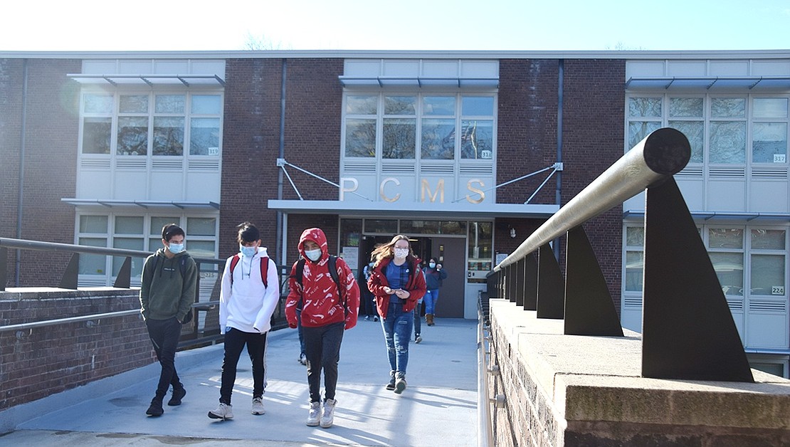 Leaving through the sleek, revamped Port Chester Middle School main entrance, masked up teenagers cross the pedestrian bridge after finishing their second in-person day of school.