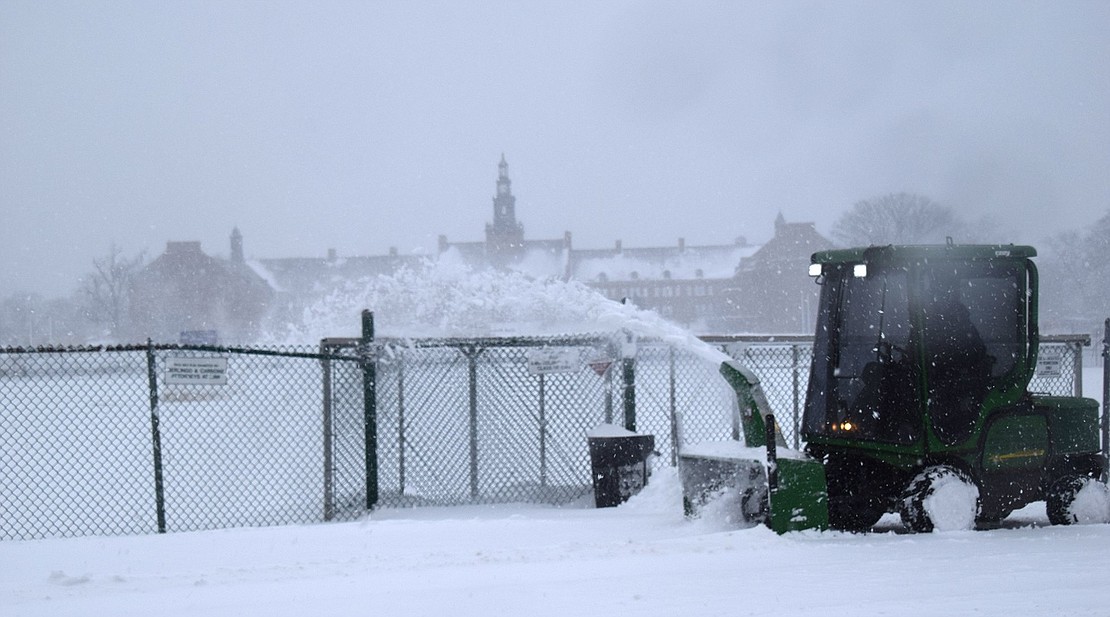 A Port Chester School District employee blows snow from the sidewalks around Port Chester High School during the blizzard on Monday, Feb. 1 which dropped about a foot of snow before ending that night.