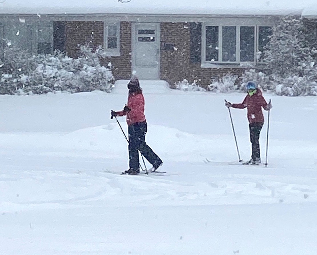 Rye Brook Trustee Stephanie Fischer and Marnie Korpi take advantage of Monday’s snowy weather to get out their cross-country skis for a tour along Woodland Drive.