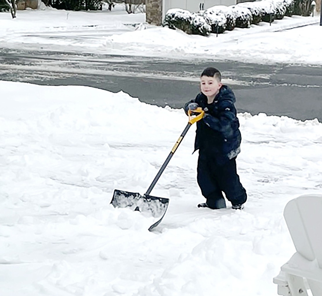 Sawyer Escott, 5, shovels his family’s driveway on Rock Ridge Drive during the Thursday, Feb. 18 snowstorm. According to his mother, Jessica, Sawyer took it upon himself to do the job, which required more than an hour of his time, “so Daddy doesn’t have to do it.” Courtesy of Jessica Escott 