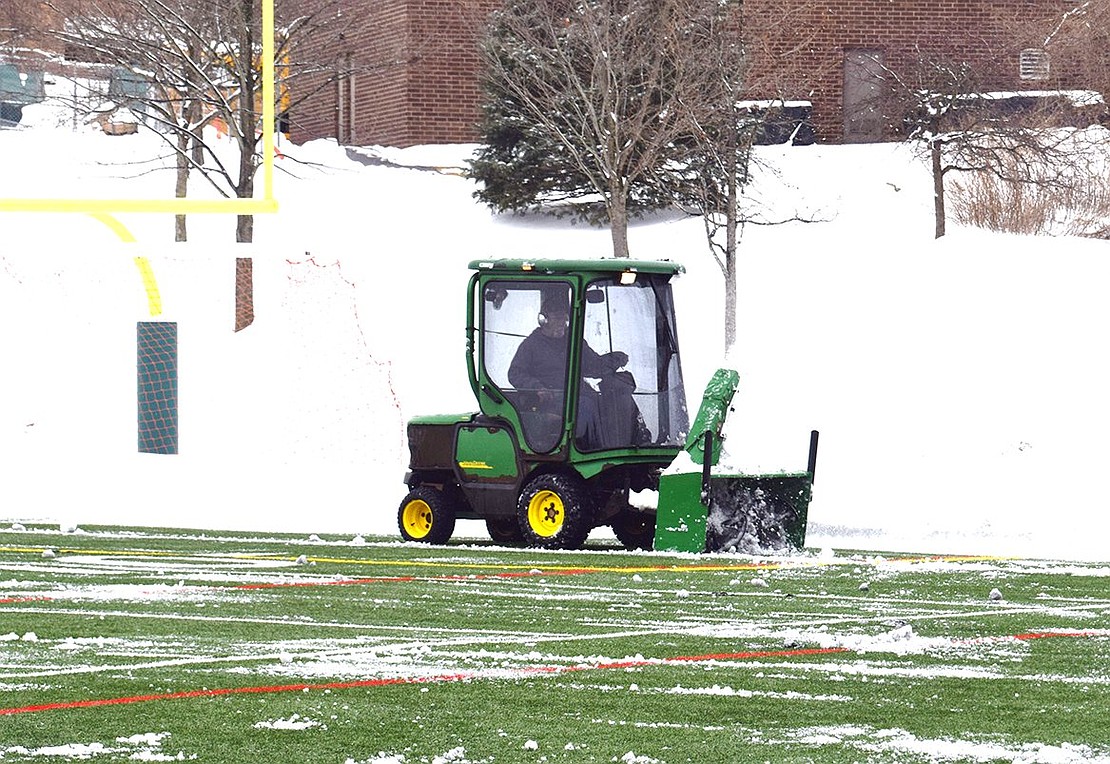 Employee clears the Rye Brook Field on King Street on Friday, Feb. 19 following the storm that started the day before but continued to drop wet snow throughout the day Friday. Jananne Abel|Westmore News 