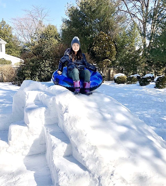 Sana Moriya figures if she’s going to build an igloo, it might as well be multi-functional. The 11 Country Ridge Dr. resident smiles for the camera as she prepares to slide down her snowy masterpiece.