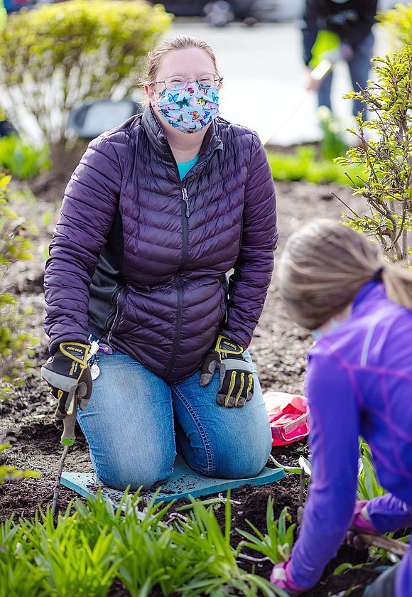 Harrison resident Christina Yedowitz, who runs the Harrison based nonprofit Rebel Butterfly Gardener, plants flowers she donated to the Village of Rye Brook. Yedowitz assists the Village in exchanging flora on municipal land with more natural, pollinator friendly plants.