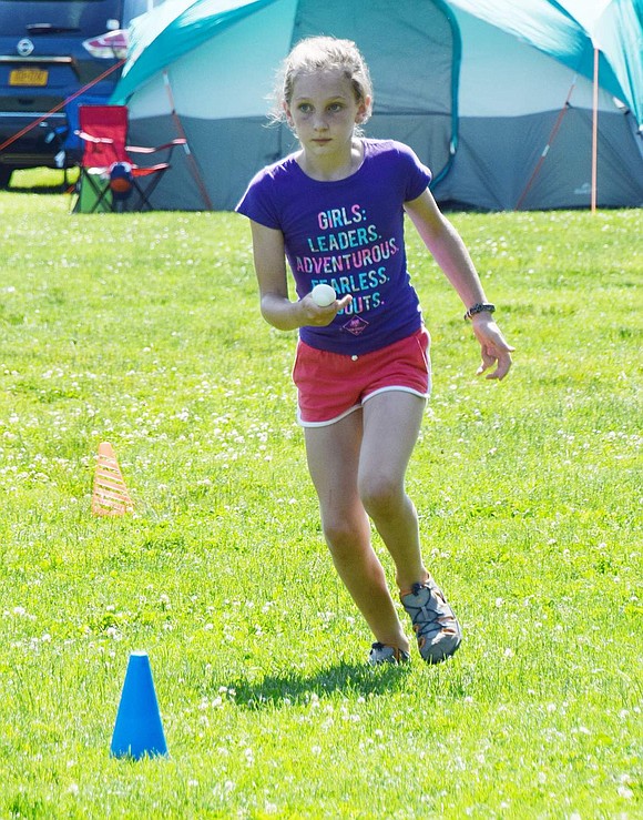 On a mission to win the egg race as the last runner on her team, Ridge Street School fifth-grader Audrey Sweeney fiercely eyes her destination while jogging with an egg balanced on her spoon.  