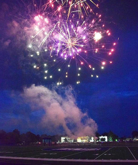 Fireworks light up the football field and Park Avenue School behind it.