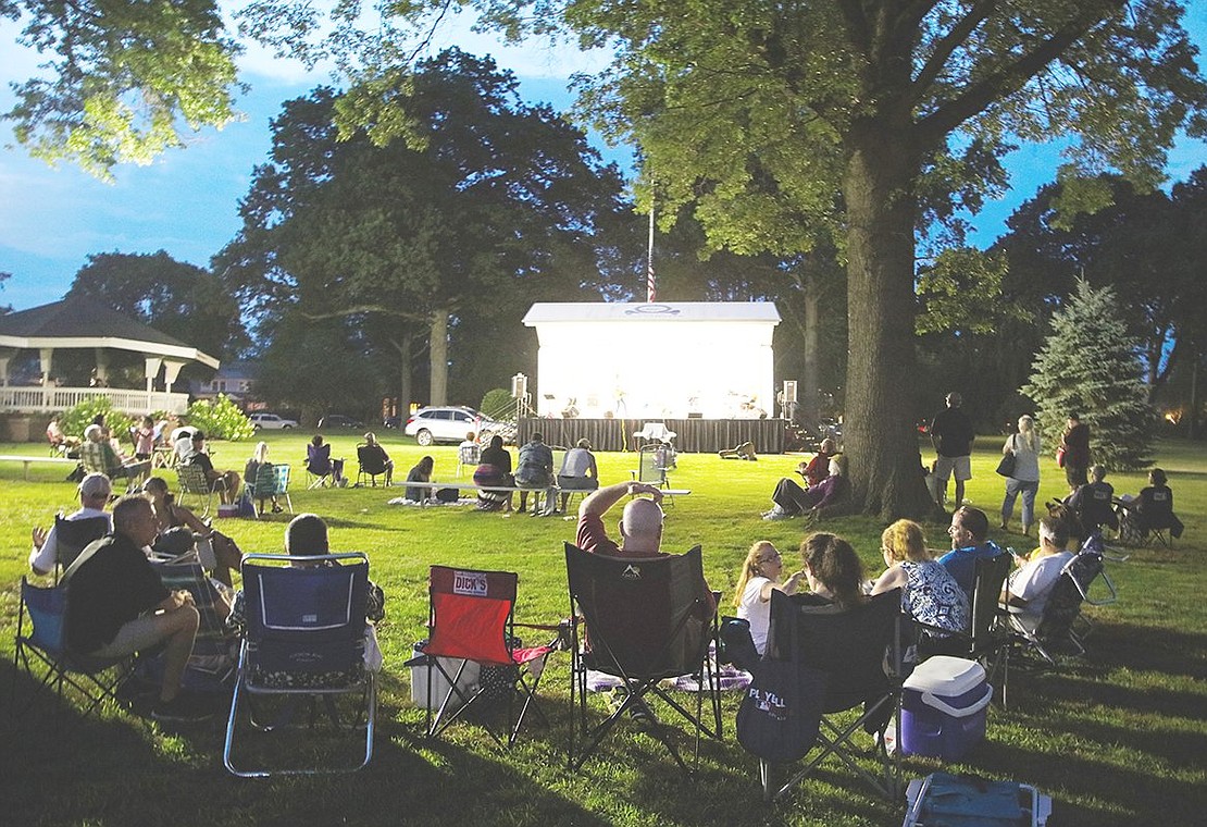 A gathering of people forms a distanced half circle around the Showmobile stage at Lyon Park on Friday, July 16. Onlookers sit in lawn chairs, some donning blankets on the cool summer night. This is the first time since COVID-19 struck that the concert series, sponsored by the Port Chester Recreation Department, has operated.