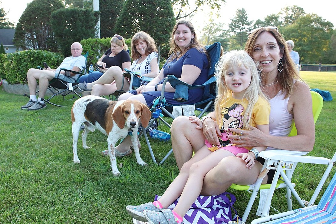 Anette Fumarelli-DeMaio (right), her daughter Melissa Sara DeMaio, their dog Snoopy, Elisabeth Slifkin, Donna Slifkin, Carol Sposato and Don Mahncke drove out early from Dobbs Ferry to get a good spot on the lawn at Pine Ridge Park. 