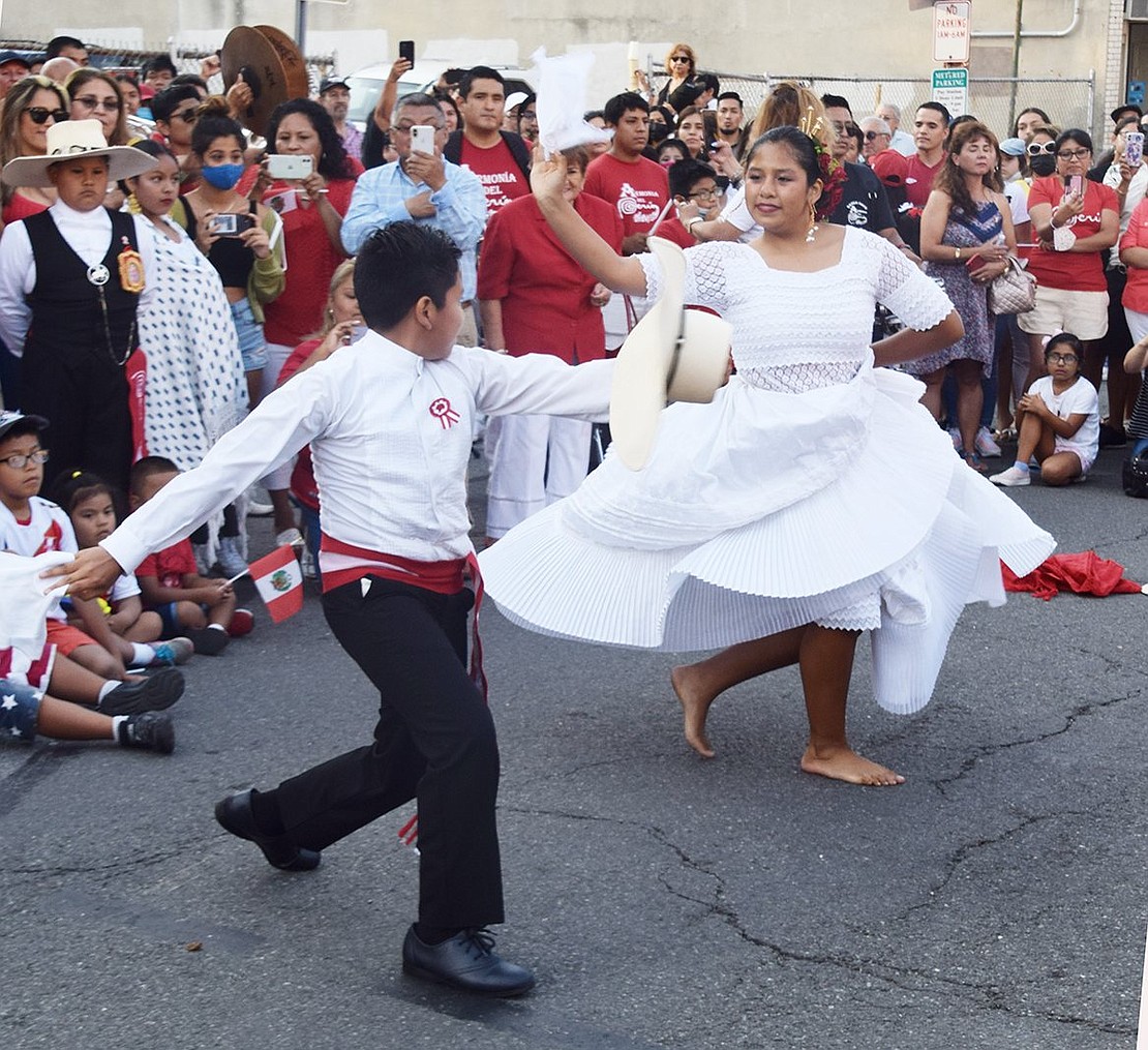 Siblings Gianmarco Soto, 15, and Kayla Soto, 12, of Westchester Avenue, Port Chester, dance the Marinera from northern Peru at the celebration.